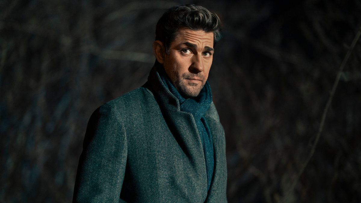 John Krasinski as Jack Ryan wearing a grey coat and blue scarf in Tom Clancy's Jack Ryan.