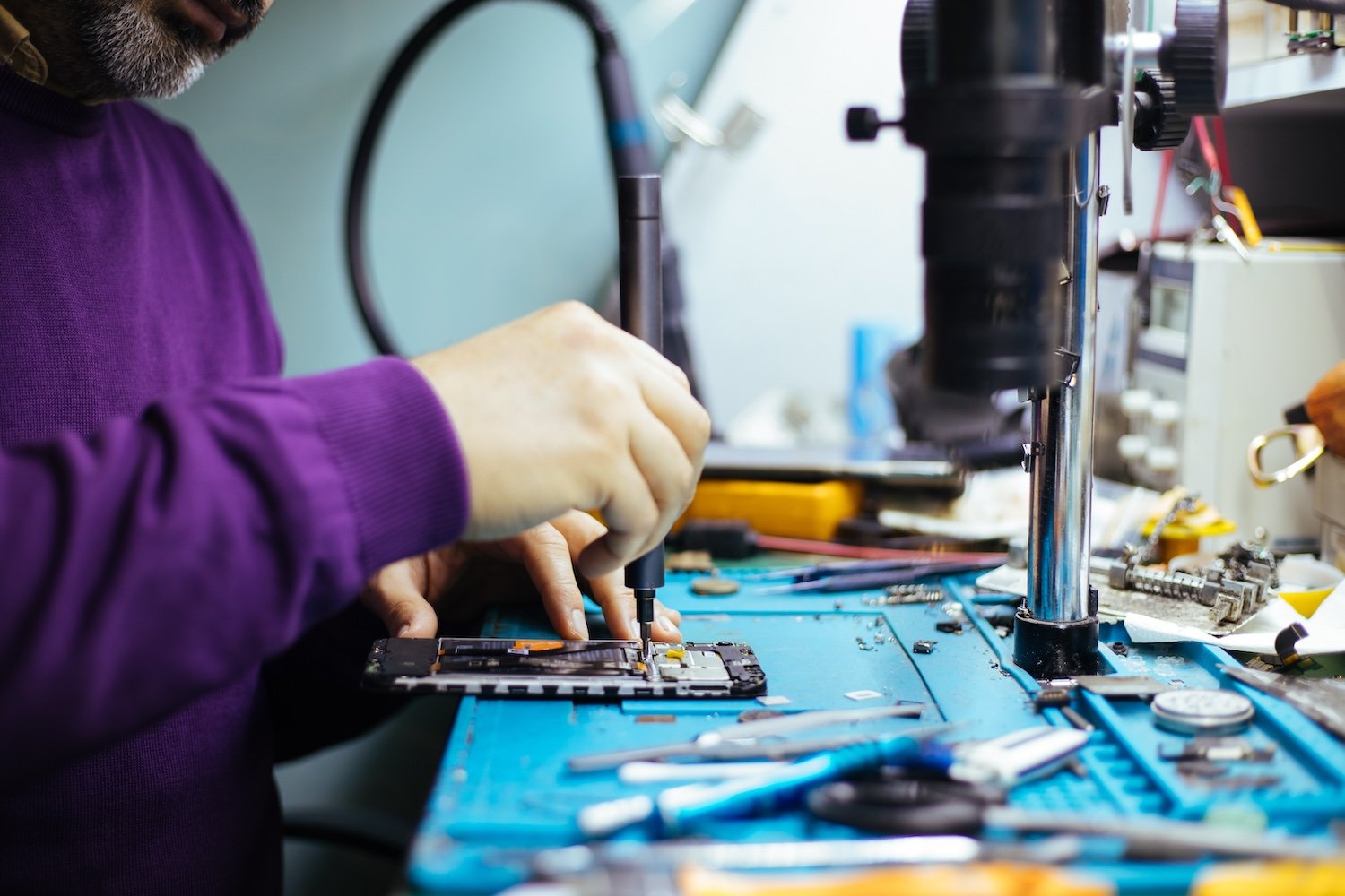 Technician repairing a smartphone.