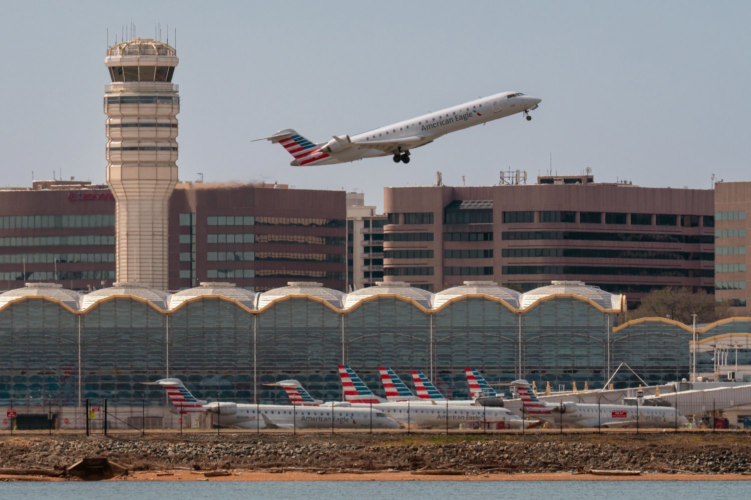 An American Eagle regional jet takes off over the American Airlines terminal at Washington Reagan National Airport