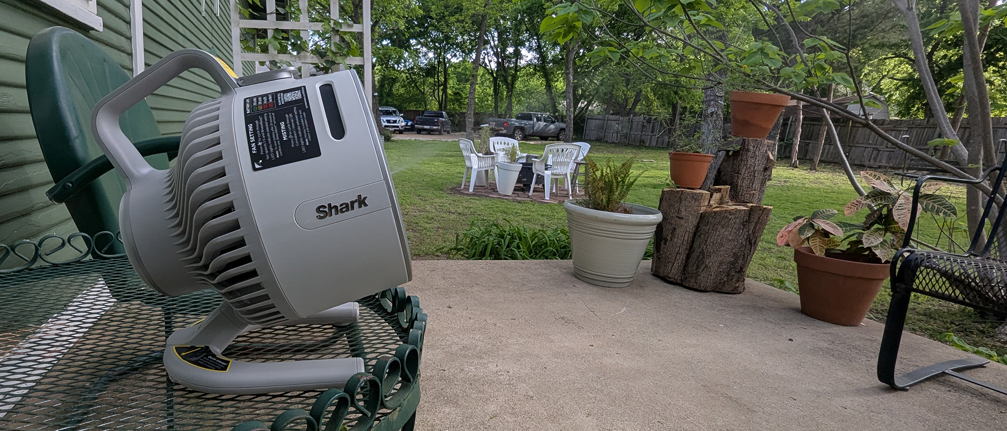 Shark FlexBreeze HydroGo portable fan in a garden
