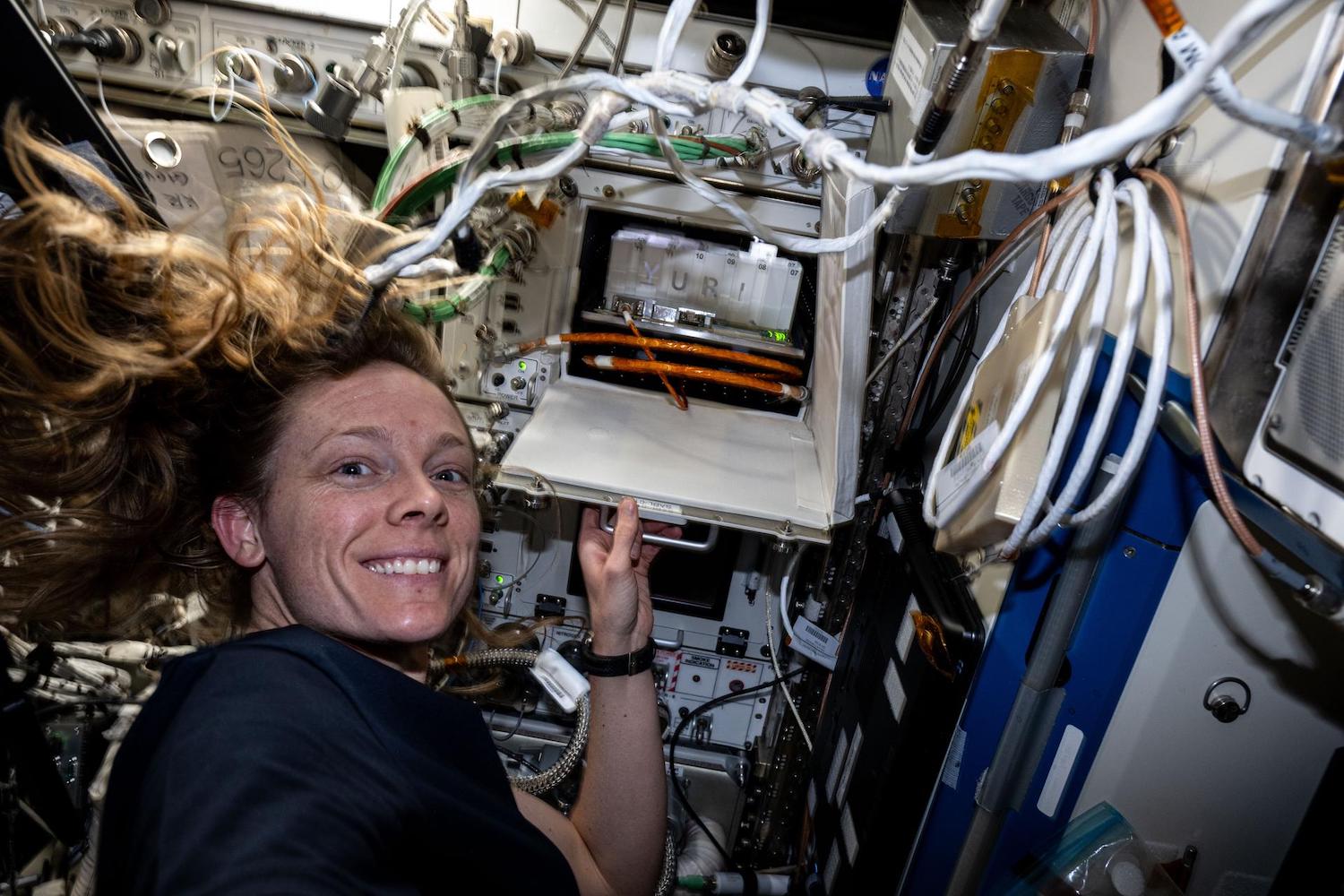 Astronaut Nichole Ayers shows off a research incubator that enables biology investigations into the effects of microgravity on cells, microbes, plants, and more