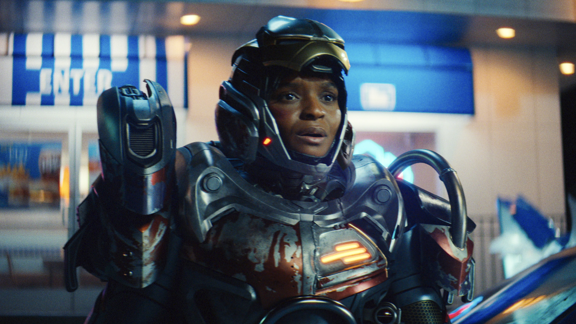 Riri Williams with her armored suit on and her mask retracted to show her face in Ironheart episode 5