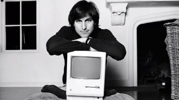 Apple co-founder Steve Jobs with a Macintosh computer.