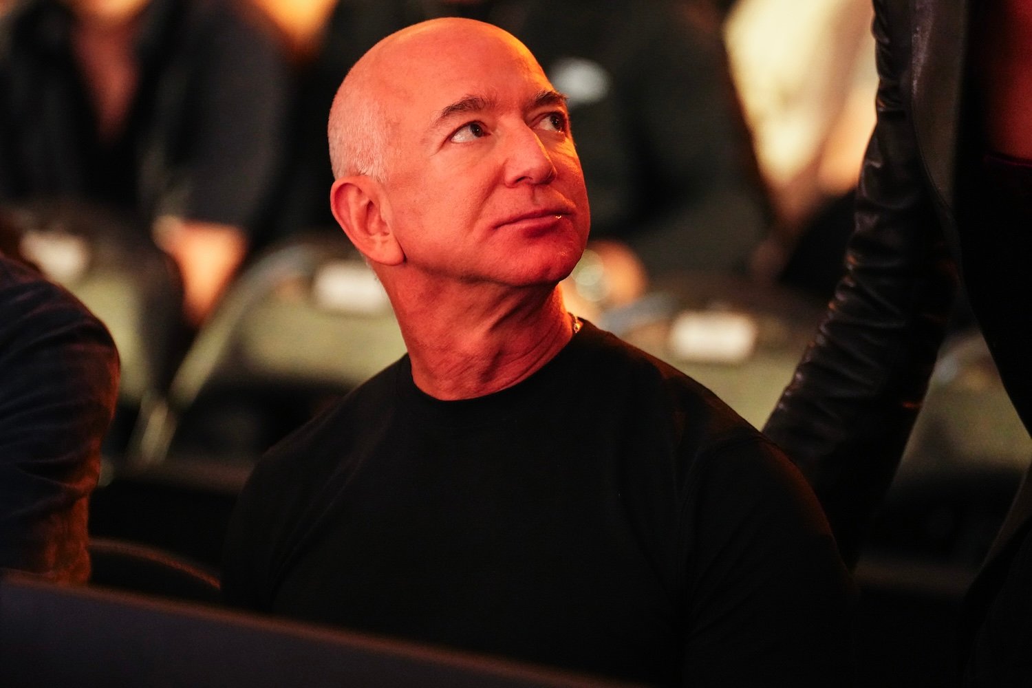 Amazon founder Jeff Bezos seated at a table, wearing a black shirt.