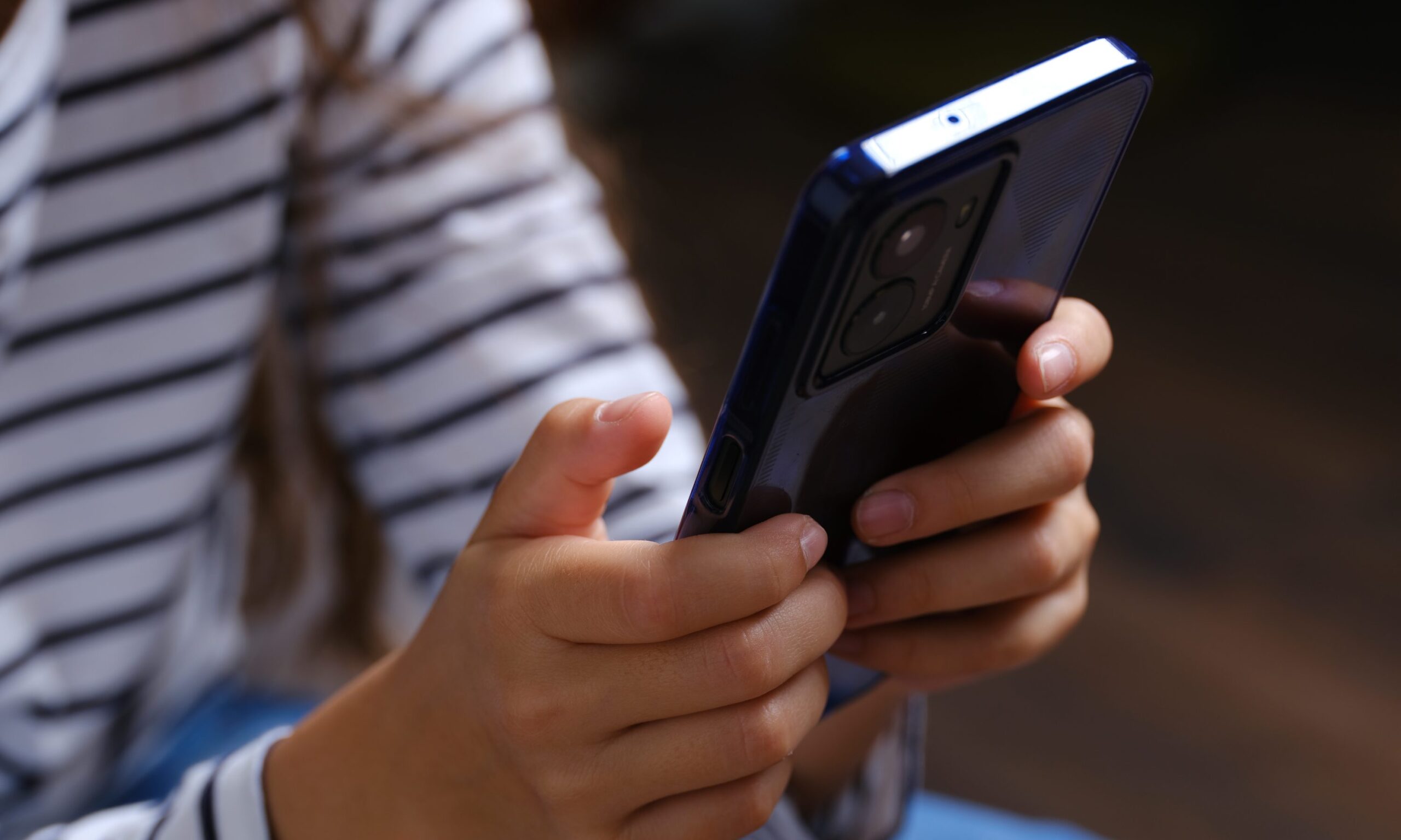 the hands of a child holding the HMD Fuse